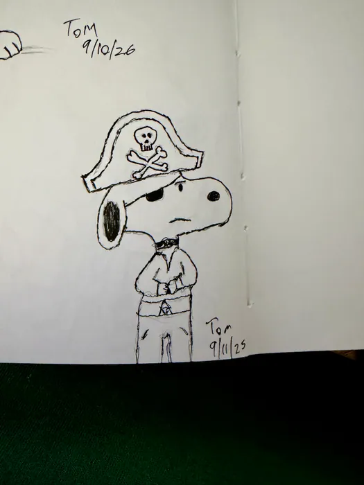 Snoopy wearing a pirate hat with a skull and crossbones.