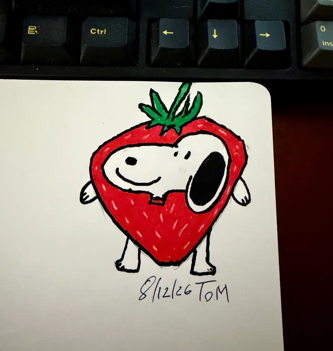 Snoopy inside a red strawberry costume.