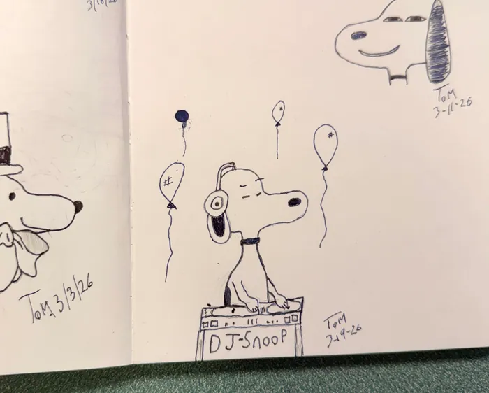 Snoopy at a DJ booth with balloons around him.