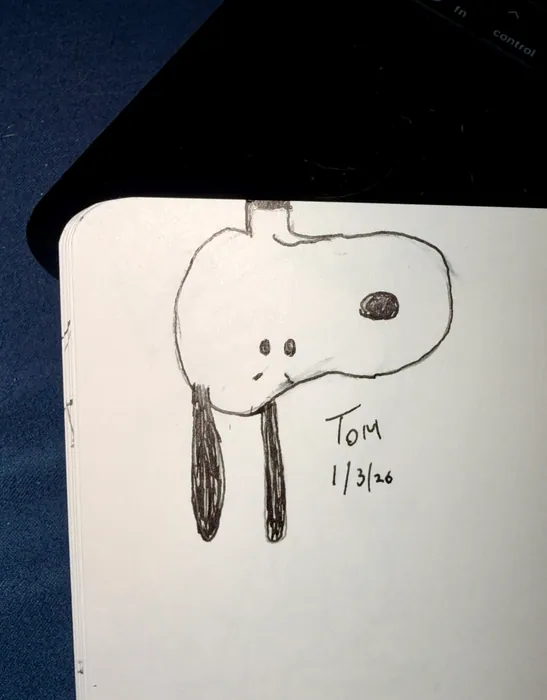 A simple drawing of Snoopy’s head with long dark ears.