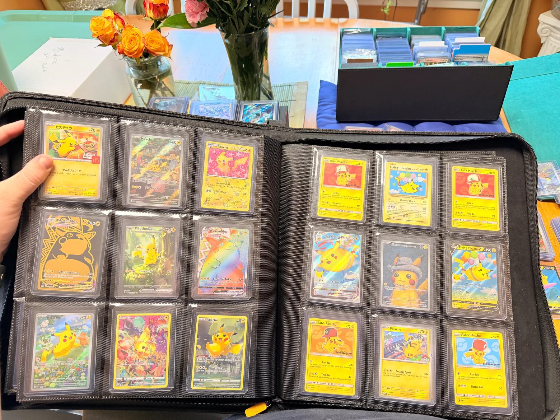 An open binder full of Pikachu cards, including a Japanese McDonald's promo, Ash's Pikachu, Flying Pikachu, and Pikachu VMAX.