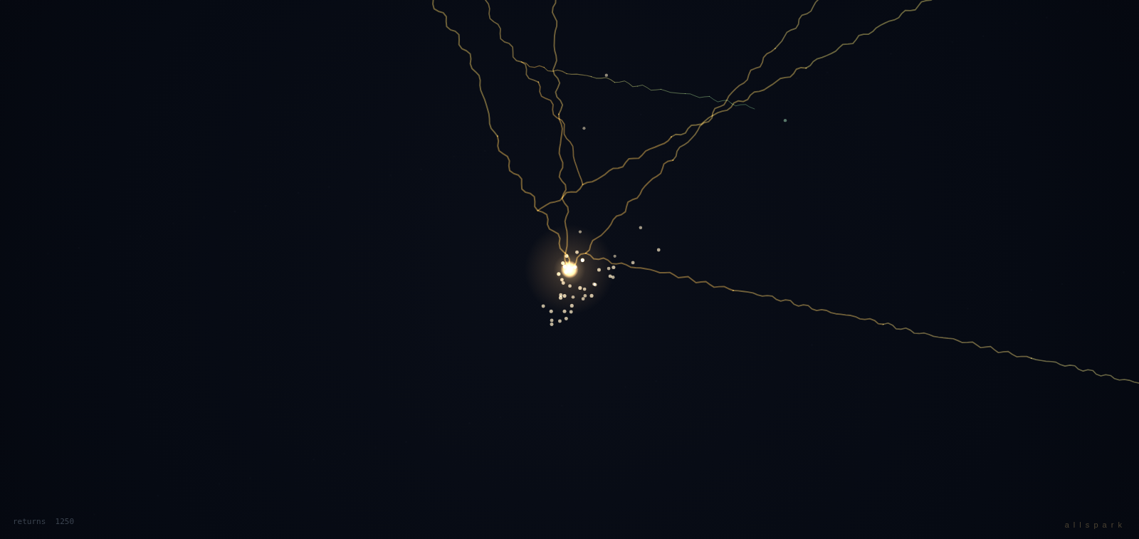 A glowing seed of light with golden filaments on a dark field.